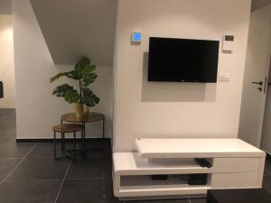 a living room with a flat screen tv on a wall at bloc79/zero in Knokke-Heist