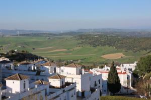 a large building with a clock on the side of it at Hostal La Janda in Vejer de la Frontera