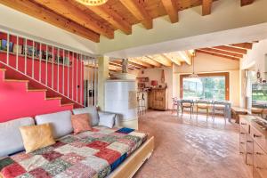 a bedroom with a bed and a kitchen with a staircase at chalet con piscina e vista panoramica in Colico