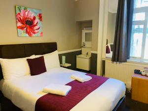 a bedroom with a large bed with two pillows on it at Horizon in Brighton & Hove