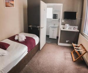 a hotel room with a bed and a bathroom at Horizon in Brighton & Hove
