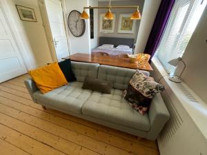 a couch with pillows on it in a living room at PetitGrandeur in Maastricht