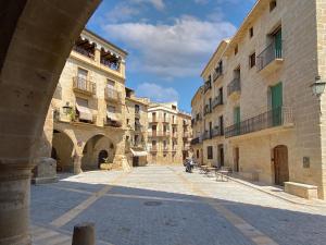 an empty street in an old town with buildings at Casa l'Escorretger in Calaceite
