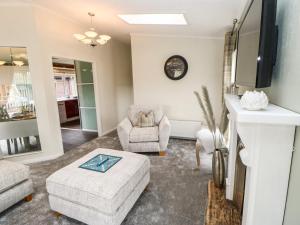 a living room with a couch and a chair at Badgers Retreat in Richmond