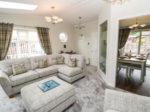 a living room with a couch and a table at Badgers Retreat in Richmond