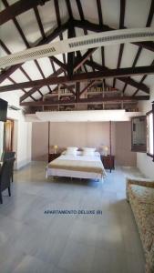 a large bedroom with a bed in a room at Apartamentos Torre de la Mezquita in Córdoba