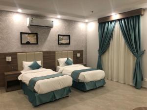 Postel nebo postele na pokoji v ubytování Al-Haramain Family Apartments