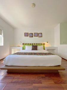 a bedroom with a large white bed in a room at Seven Crown Express & Suites by Kavia in Cabo San Lucas