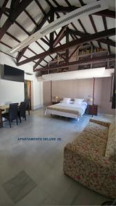 a bedroom with two beds and a table and chairs at Apartamentos Torre de la Mezquita in Córdoba