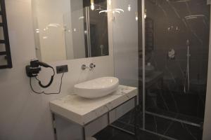 a bathroom with a sink and a shower at Atmosfera Apartament 5 in Bytów