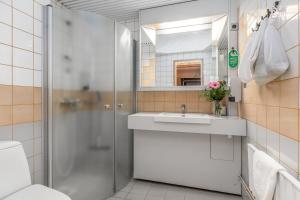 a bathroom with a shower and a sink at Hotel Kurikka in Kurikka