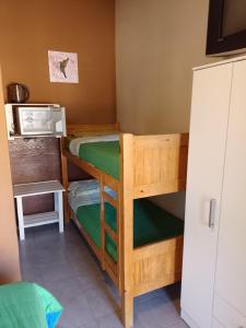 a small room with two bunk beds in it at Complejo Los Gringos in Villa Ciudad de America +39 photos