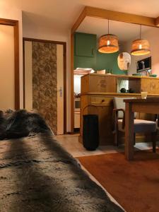 a kitchen with a table and a dining room at Nid Douillet à la Louvée in Combloux
