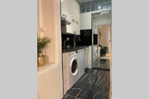 - une cuisine avec lave-linge et sèche-linge dans la chambre dans l'établissement Studio COSY et confortable aux PORTES DE PARIS!, à Saint-Denis