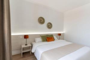 Ein Bett oder Betten in einem Zimmer der Unterkunft Apartamentos Venecia