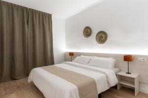 Ein Bett oder Betten in einem Zimmer der Unterkunft Apartamentos Venecia