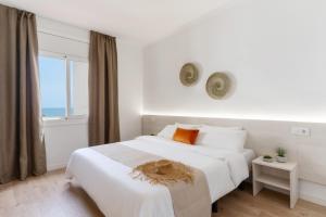 Ein Bett oder Betten in einem Zimmer der Unterkunft Apartamentos Venecia