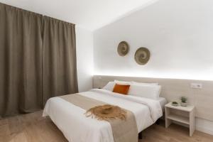 Ein Bett oder Betten in einem Zimmer der Unterkunft Apartamentos Venecia