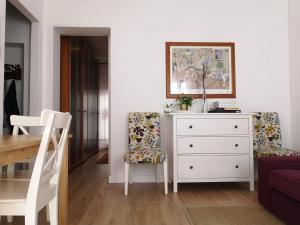 a living room with a dresser and a table and chair at Apartment Ca' Petrona in Venice