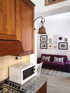 a kitchen with a microwave and a living room at Apartment Ca' Petrona in Venice