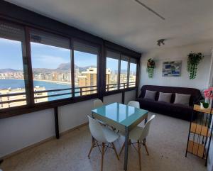 a living room with a table and chairs and a couch at Apartment Diamond in Benidorm