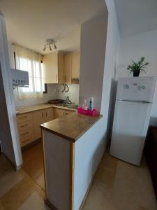 a kitchen with a white refrigerator and a counter at Apartment Diamond in Benidorm