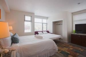 a bedroom with two beds and a flat screen tv at Comfy Studio with Cali King Size Mattress in San Diego