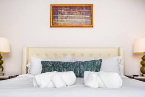 a bedroom with a white bed with white pillows at Comfy Studio with Cali King Size Mattress in San Diego +33 photos