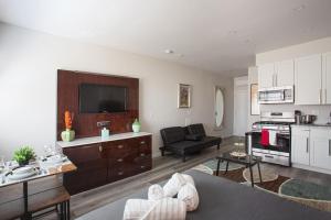 a large living room with a couch and a kitchen at Lovely Studio w Full Kitchen in Heart of San Diego in San Diego