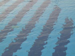 a reflection of a person in the water at Cathrin Hotel in Faliraki