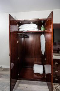 a wooden cabinet with a bed and towels in a room at Downtown View 4 Sleepers Studio- Great for Getaway in San Diego