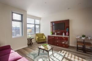 a living room with a couch and a tv at One Bedroom Apartment with SD Downtown View in San Diego