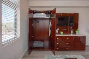 a room with a tv and a cabinet with a dresser with a tvicter at One Bedroom Apartment with San Diego Downtown View in San Diego