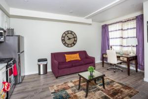 a living room with a purple couch and a desk at 1 Bedroom Apartment with Luxurious Design in SD in San Diego