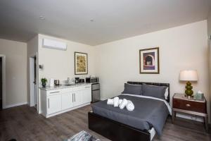 a bedroom with a large bed and a kitchen at Explore San Diego-Balboa Park-Little Italy-Gaslamp in San Diego