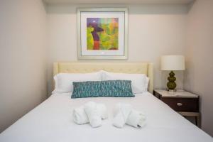 a bedroom with a white bed with two pillows at The Most Beautiful Bay View from 1 Bedroom Apt in San Diego