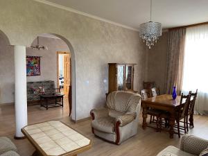 a living room with a table and chairs and a dining room at Brewery House&Beer Spa in Aspindza