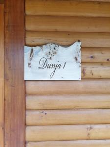 a sign on the side of a wooden wall at Brvnare Dunja 1 i Dunja 2 in Kraljevo