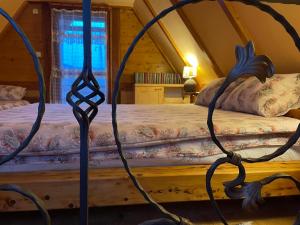 a bedroom with two beds in a attic at Brvnare Dunja 1 i Dunja 2 in Kraljevo