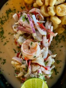 a plate of shrimp and potato salad with a lime wedge at Eco Xata in Santa Verónica +195 photos