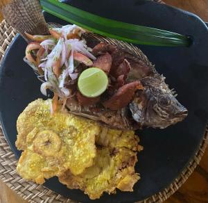 a plate of food with a fish and a salad at Eco Xata in Santa Verónica