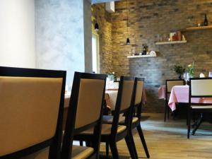 a dining room with tables and chairs and a brick wall at Restaurant Blume in St. Gallen