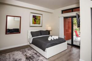 a bedroom with a bed and a mirror at Explore Balboa Park From Your Cozy Studio w Patio in San Diego