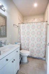 a bathroom with a toilet and a shower curtain at Studio with Beautiful View next to Downtown in San Diego