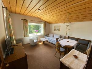 a living room with a couch and a table at Appartement Latschen - Ferienhaus in Bad Kleinkirchheim