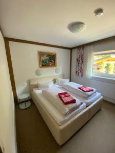 a bedroom with two beds with red towels on them at Appartement Latschen - Ferienhaus in Bad Kleinkirchheim