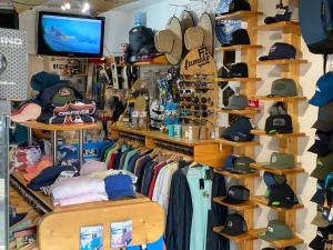 a store with hats and other items on shelves at Red Star Surf & Yoga Camp Lanzarote in Famara