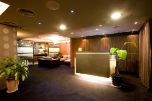 a living room with plants in a room with a couch at H.M.Hotel in Hsinchu City