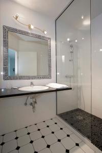 a bathroom with a sink and a mirror at Hotel Restaurant Champ Alsace in Haguenau