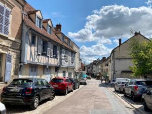 a street with cars parked on the side of the road at Provins au coeur du quartier historique - Charmant studio pour 2 in Provins